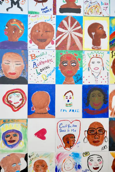 A collage of small square paintings depicts bald people and features the words Beautiful, Authentic, Loving, Determined, Im Free, and Cant You See Bald is Me.